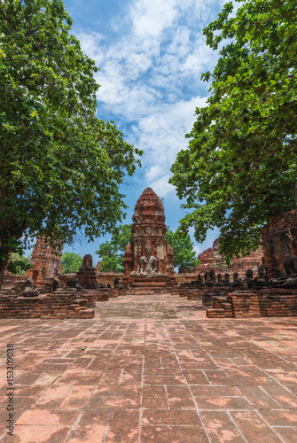 Ruins of buddha statues and pagoda of Wat Mahathat in Ayutthaya historical park, Thailand