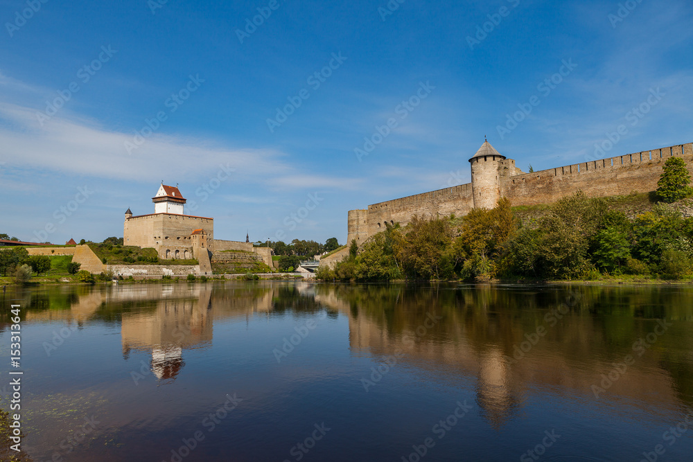 Two medieval fortresses on the river Narva, Estonia and Russia border. Summer day view.