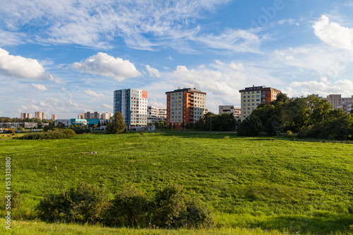 New modern blocks of flats in green area with blue sky at summer day. Northern friendly style. © yegorov_nick