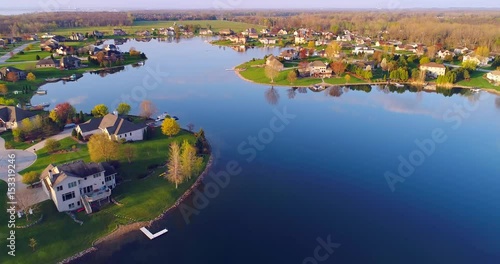 Beautiful waterfront homes on lake at sunrise in Springtime.
 photo