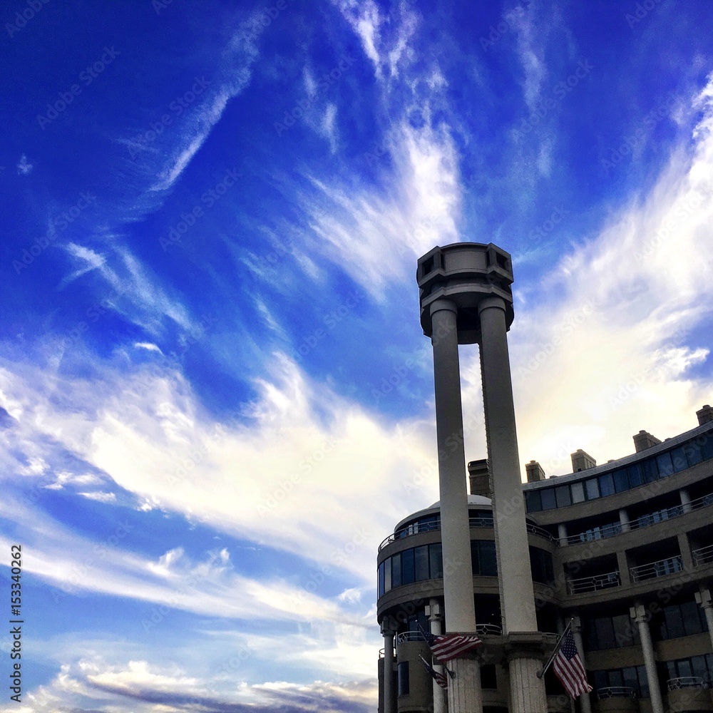 blue skies and wispy clouds in urban environment
