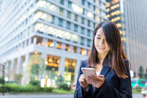 Businesswoamn use of mobile phone in Tokyo city photo