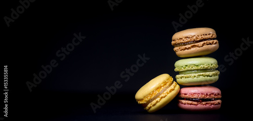 Cake macaron or macaroon isolated on black background, sweet photo
