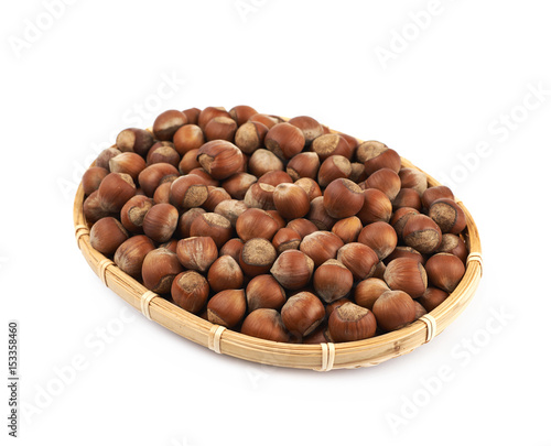 Wicker basket of hazelnuts isolated