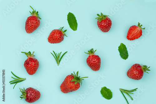 seamless pattern of strawberries, mint and rosemary leaves shot from above