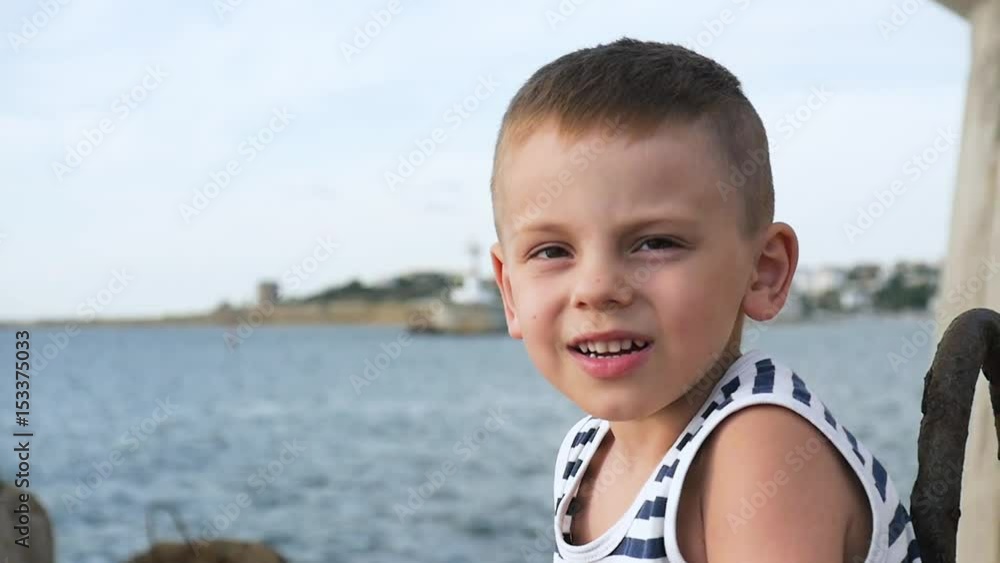 adorable little boy in sailor stripes shirt on sky and sea background adorable little boy in sailor stripes shirt on sky and sea background