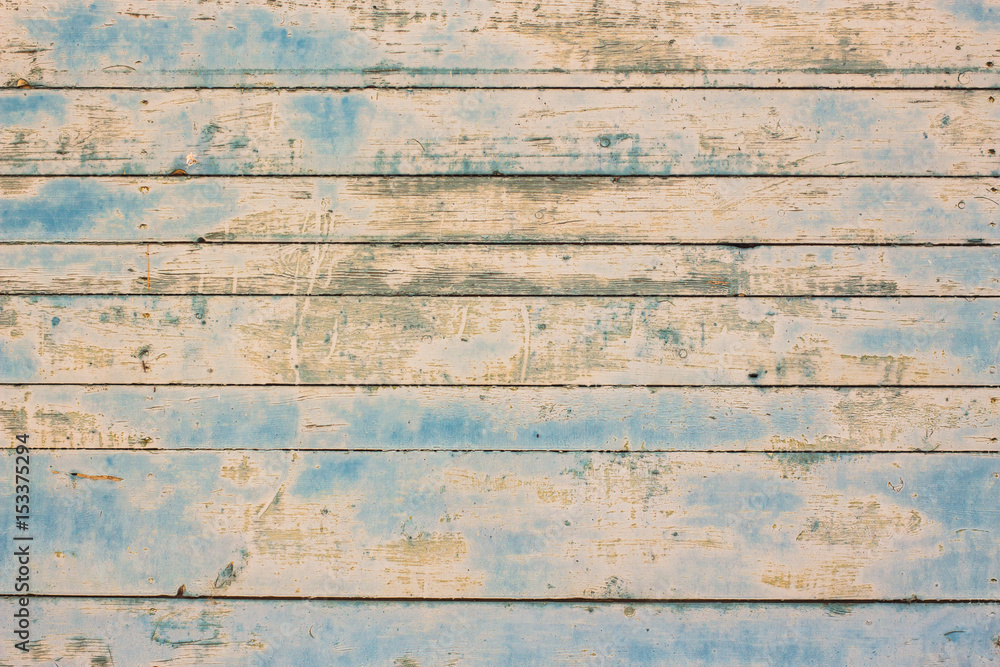 Beautiful light blue and brown wooden texture background. Closeup of weathered painted wooden planks of old house or barn. Horizontal color photography.