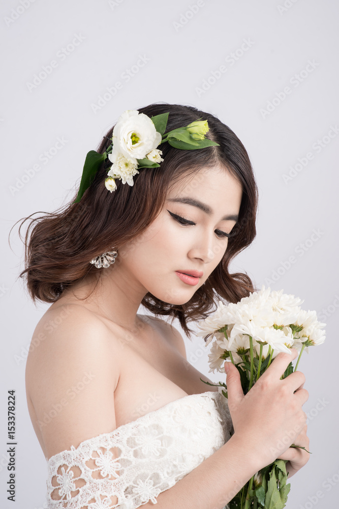 Beautiful asian woman bride on grey background. Closeup portraits with a professional makeup Beautiful asian woman bride on grey background. Closeup portraits with a professional makeup