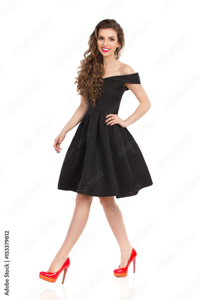 Young Woman In Elegant Black Cocktail Dress Is Walking