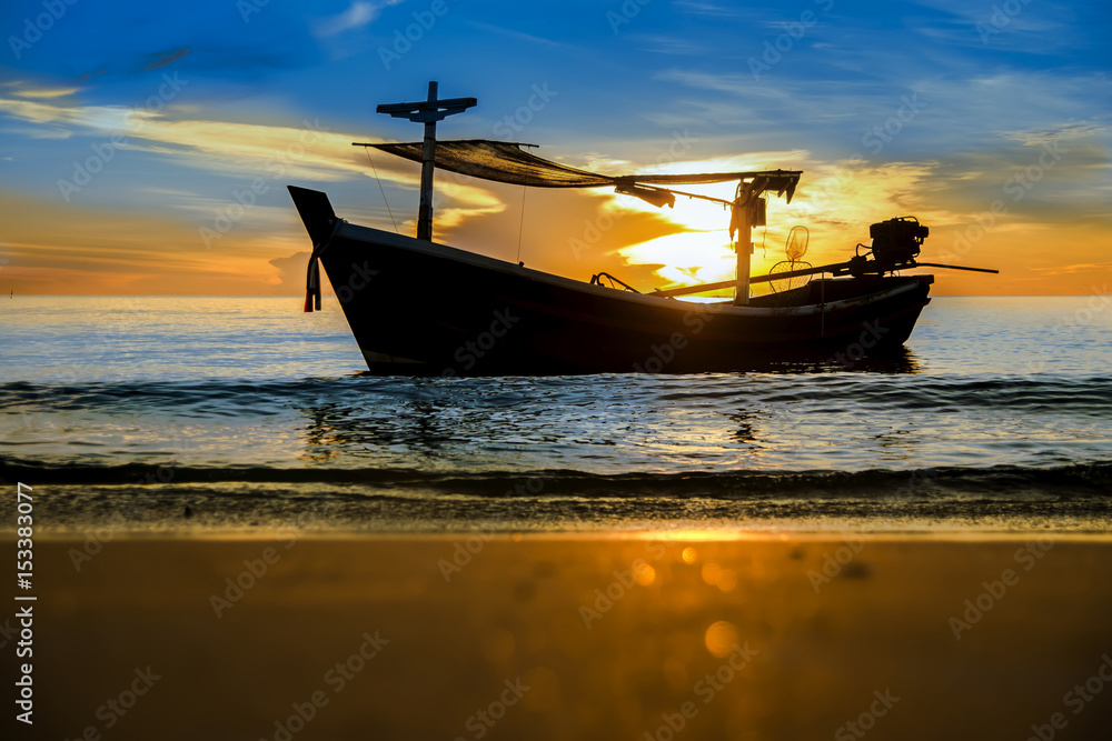 Silhouettes of Fishing boat on the beach.
