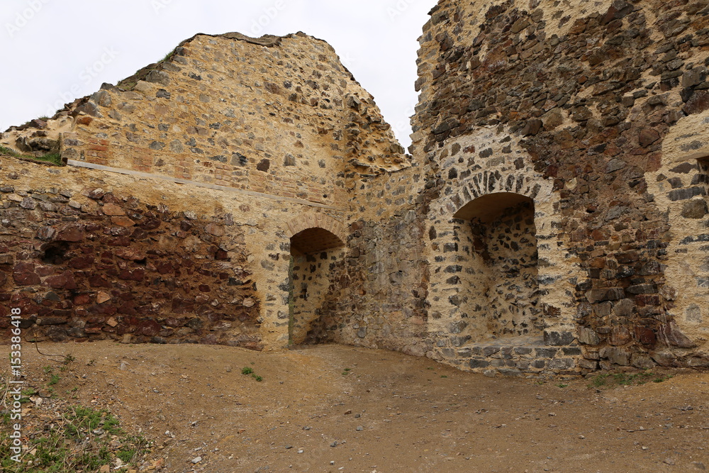 Secured ruins of old castle walls with doors and recess
