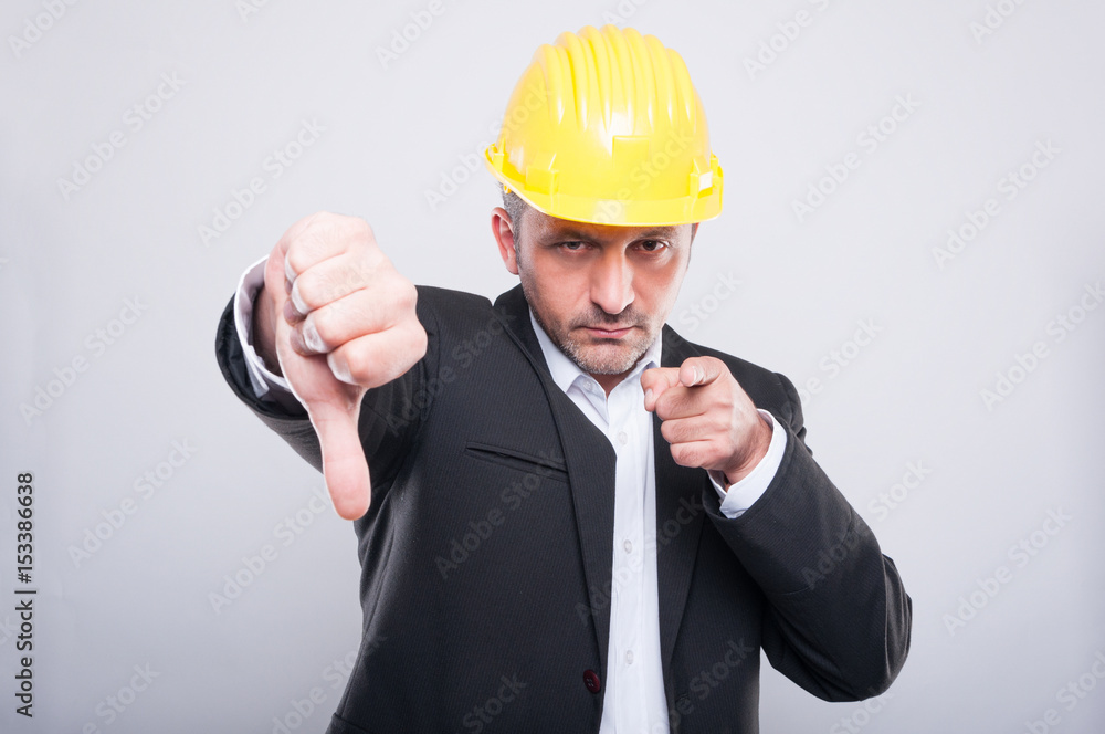 Foreman making thumb down gesture and pointing