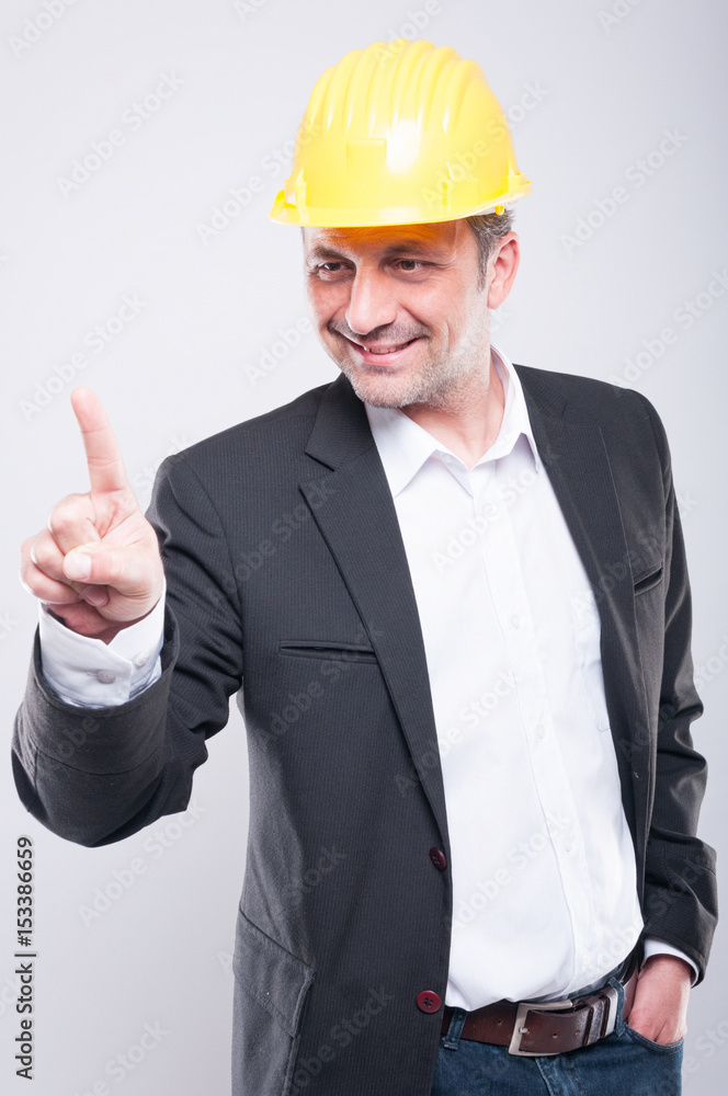 Foreman wearing hardhat making slide gesture