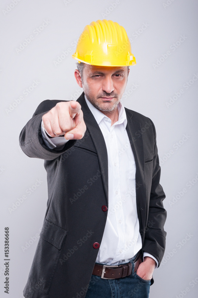 Portrait of foreman wearing hardhat pointing camera Portrait of foreman wearing hardhat pointing camera