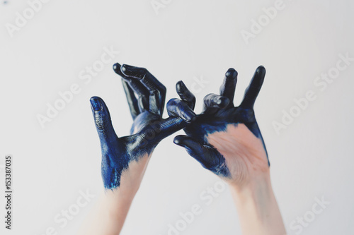 Painted blue crossed fingers