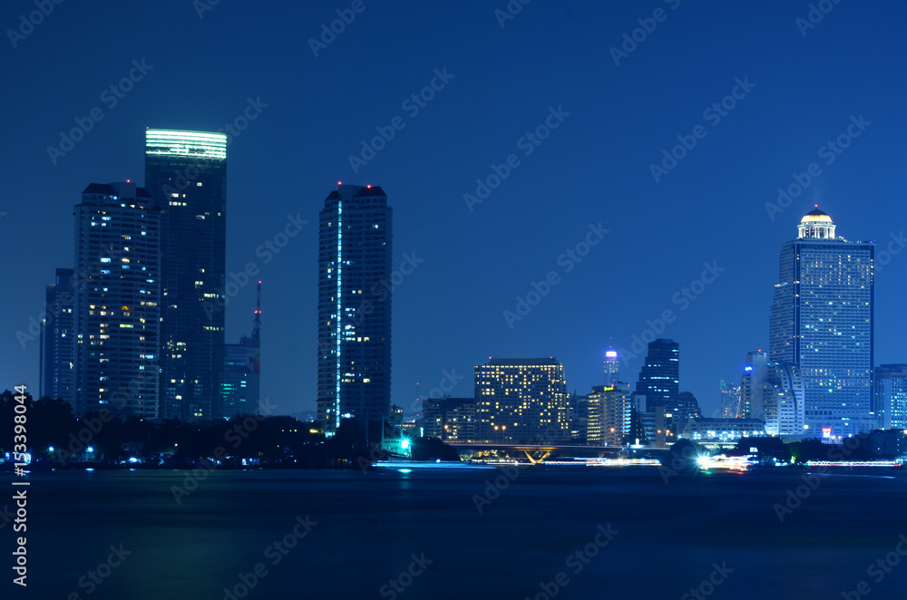 bangkok city skyline from the Chao Phraya River by night Light passing