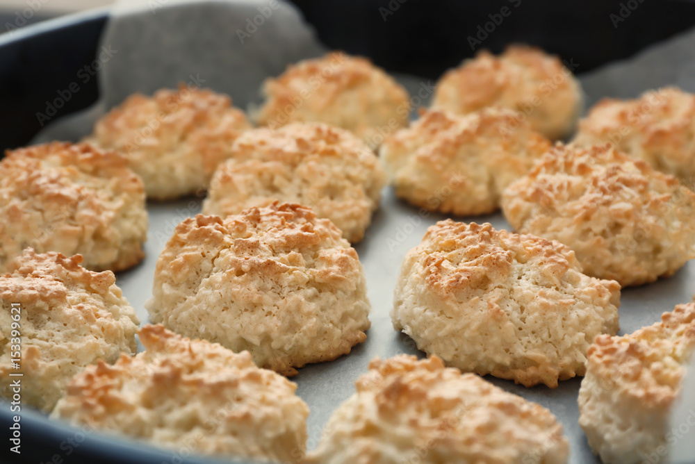 Baking tray with delicious coconut macaroons, closeup Baking tray with delicious coconut macaroons, closeup