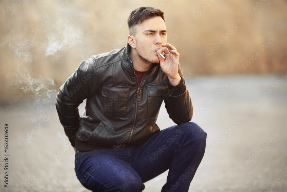 Handsome young man smoking weed outdoors Handsome young man smoking weed outdoors