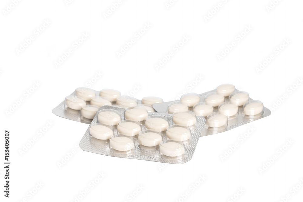 Medicinal white pills with expired shelf life on a white background. Isolated Medicinal white pills with expired shelf life on a white background. Isolated