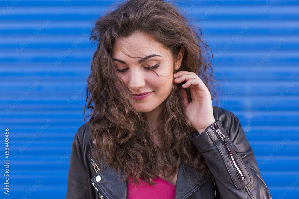 outdoors portrait of a beautiful Young woman over blue background. Happy. Colorful and lifestyle. outdoors portrait of a beautiful Young woman over blue background. Happy. Colorful and lifestyle.