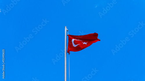 turkish flag waving in blue sky