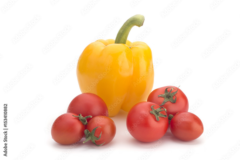 Yellow sweet pepper and red cherry tomatoes on a white background Yellow sweet pepper and red cherry tomatoes on a white background