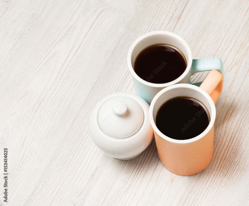 Two cups of coffee on white wooden table. Top view, flat lay. Two cups of coffee on white wooden table. Top view, flat lay.