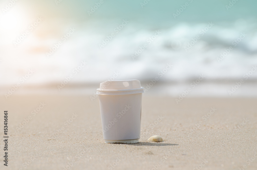 plastic coffee cup and sea sand plastic coffee cup and sea sand