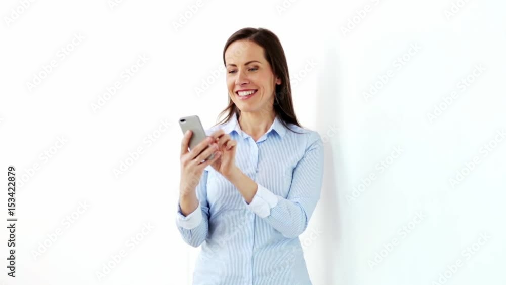 happy businesswoman with smartphone at office happy businesswoman with smartphone at office