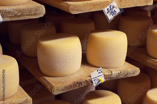 Tablou pe pânză Cheese factory production shelves with aging cheese