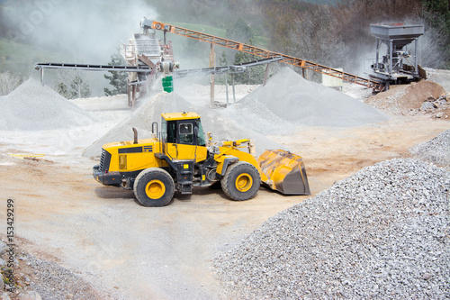 Quarry aggregate with heavy duty machinery photo