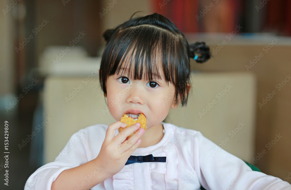 Close up of little asian girl eating fried chicken in cafe. Close up of little asian girl eating fried chicken in cafe.