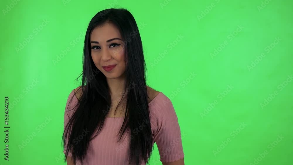 young attractive asian woman waves with hand - green screen studio young attractive asian woman waves with hand - green screen studio