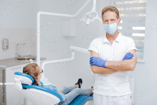Gifted local dentist working with little patient
