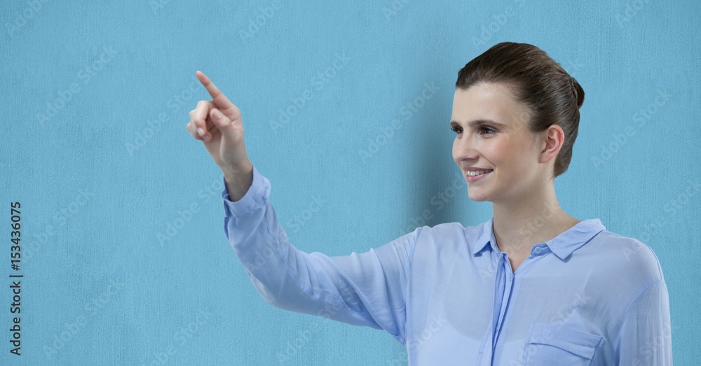 Smiling businesswoman pointing over blue