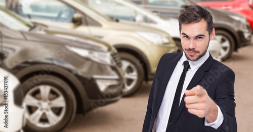 Businessman pointing against car in showroom © vectorfusionart