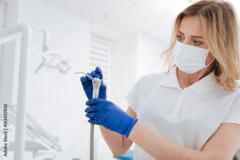 Charming focused doctor checking her tools Charming focused doctor checking her tools