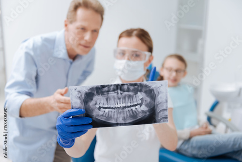 Observant determined dentist indicating problems