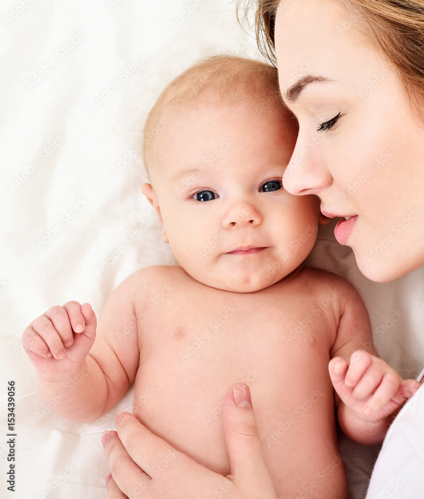 Mother and baby playing and smiling. Happy family. Mother and baby playing and smiling. Happy family.