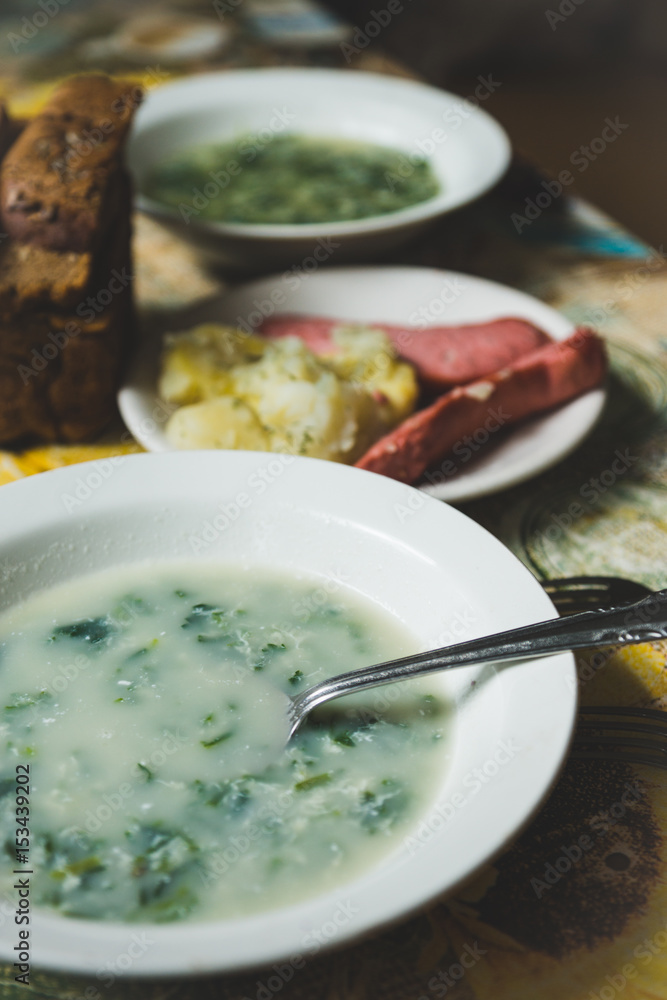 Cream soup with herbs in white plate. Shallow depth of field. Cream soup with herbs in white plate. Shallow depth of field.