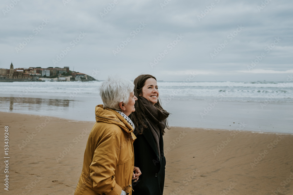 Beautiful images of a mother and daughter on the beach in Autumn. Lifestyle portraits. Beautiful images of a mother and daughter on the beach in Autumn. Lifestyle portraits.