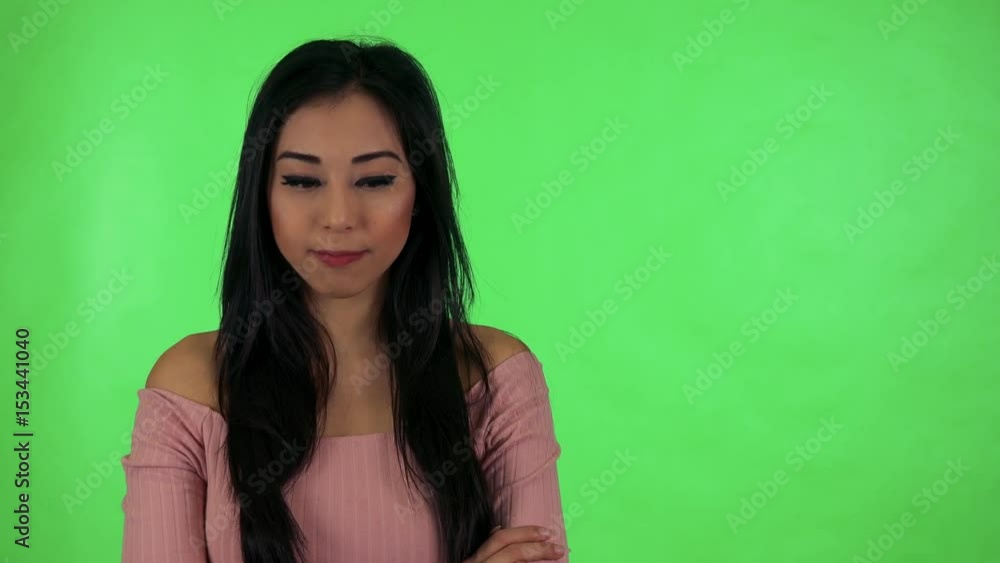 young attractive asian woman agrees (move with head on yes) - green screen young attractive asian woman agrees (move with head on yes) - green screen