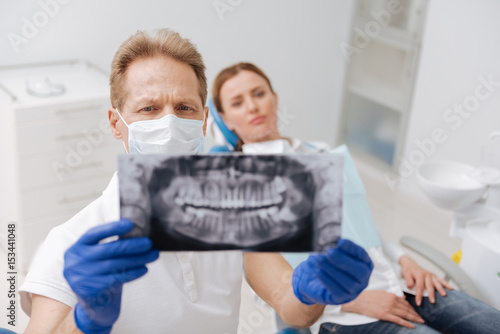 Dedicated learned dentist studying patient jaw scan
