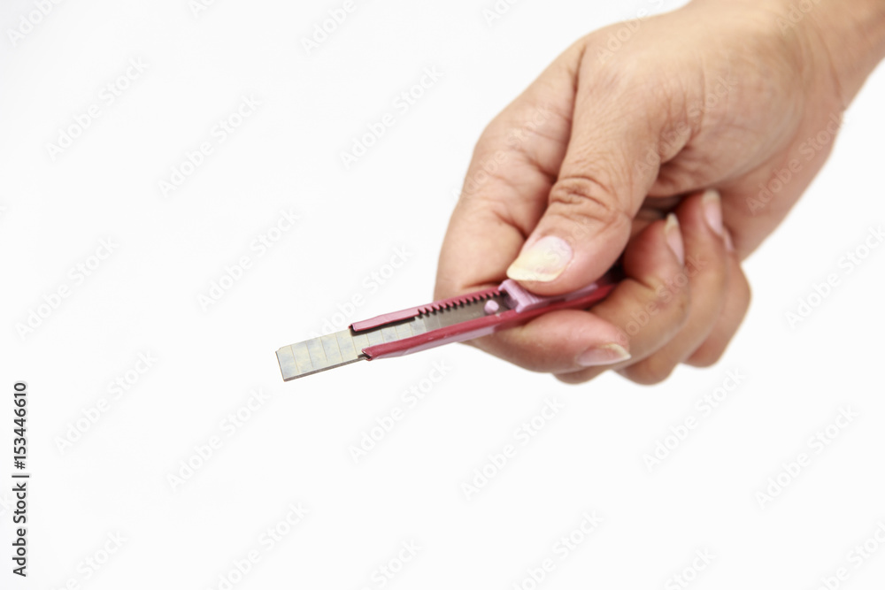 hand holding a cutter knife isolated white. hand holding a cutter knife isolated white.