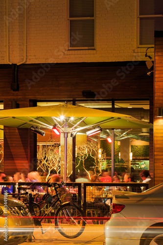 Carytown Richmond Va street scene looking into busy restaurant on a Friday night.