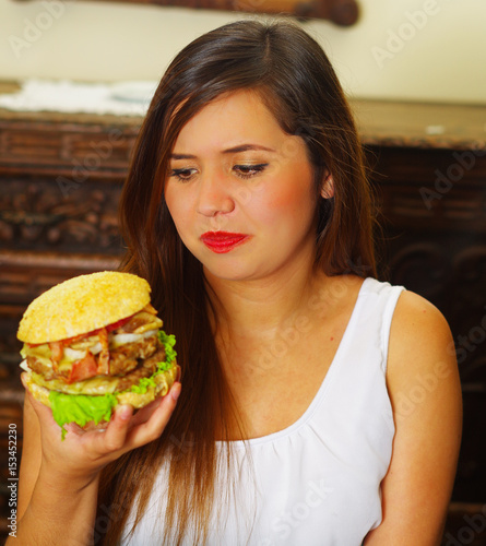 beauty woman in cafe watching a delicious hamburger