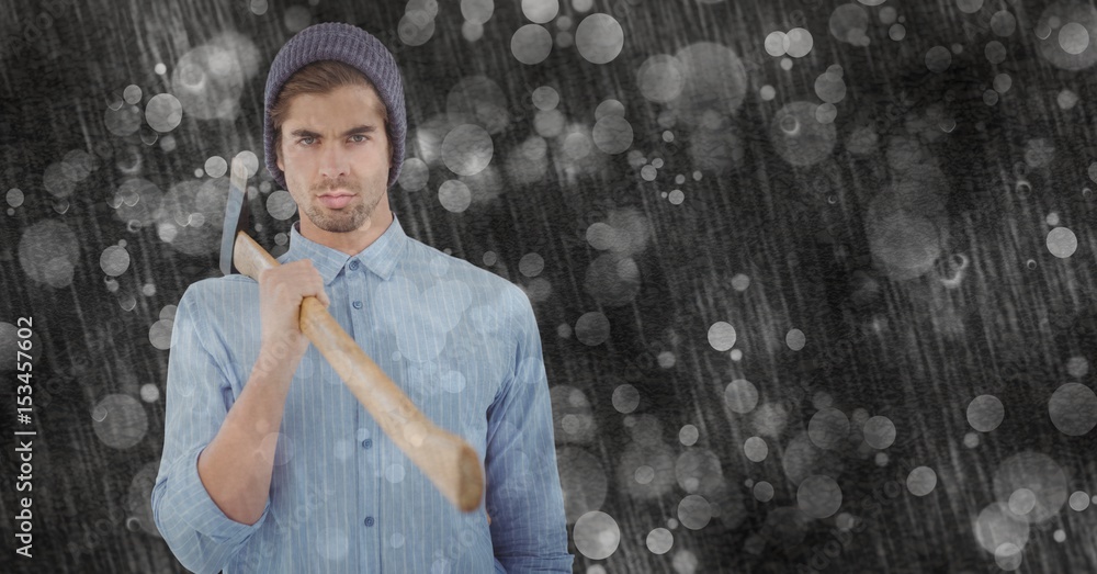 Confident hipster holding ax on rainy day