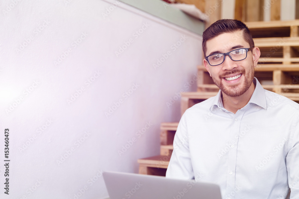 Portrait of young man sitting at the stairs in office Portrait of young man sitting at the stairs in office