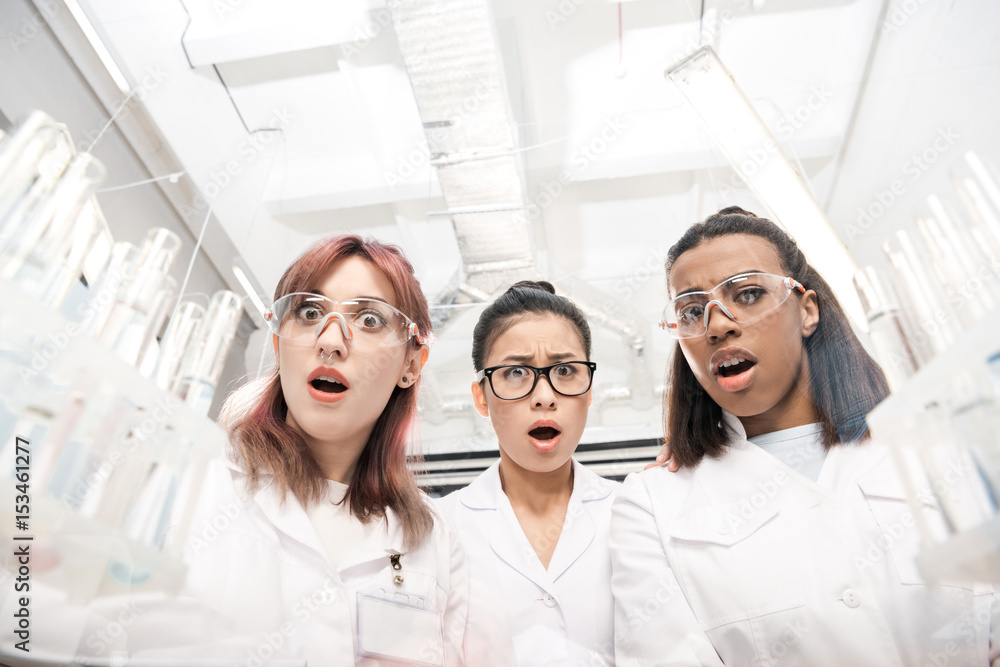 low angle view of scientists group in white coats in laboratory low angle view of scientists group in white coats in laboratory