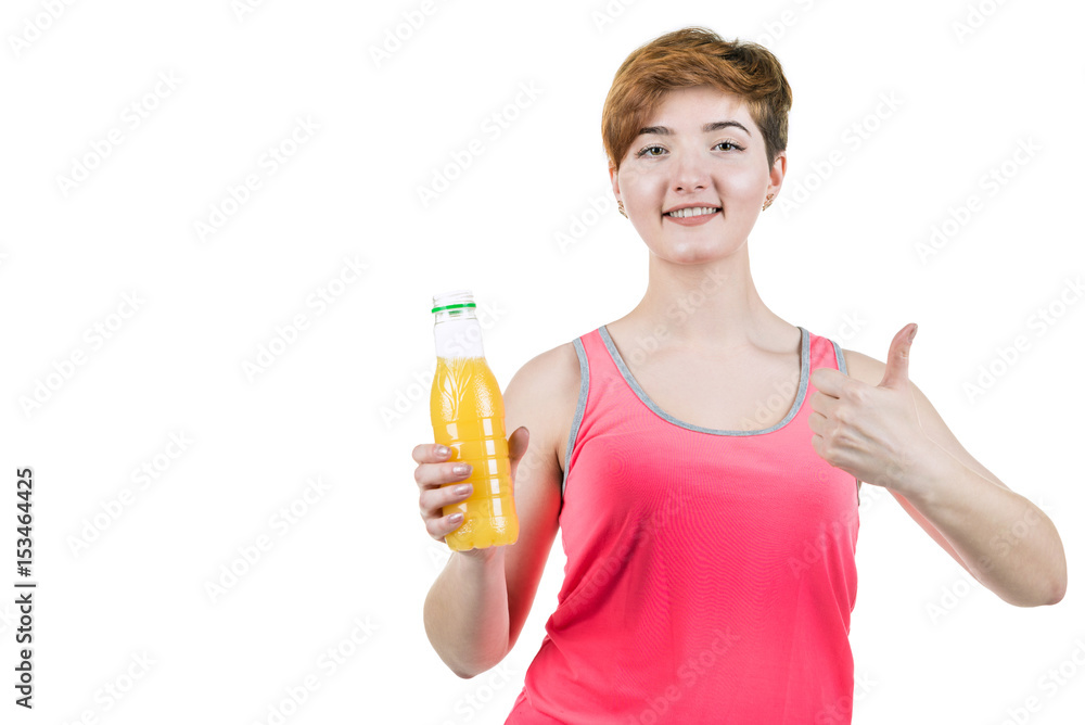 Healthy lifestyle, healthy eating. Young girl with a bottle of orange juice in her hand, smiling with a thumb up, on a white isolated background. Horizontal frame Healthy lifestyle, healthy eating. Young girl with a bottle of orange juice in her hand, smiling with a thumb up, on a white isolated background. Horizontal frame